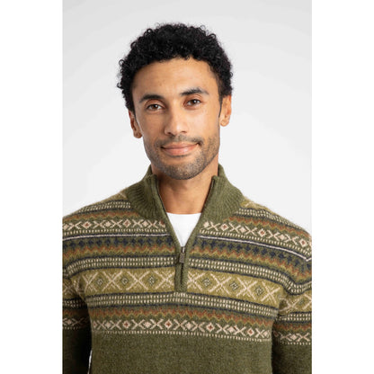 Close-up view of a man wearing a Weird Fish 1/4 zip Larner knitted jumper in Winter Green with a Fair Isle pattern across the chest and shoulders.