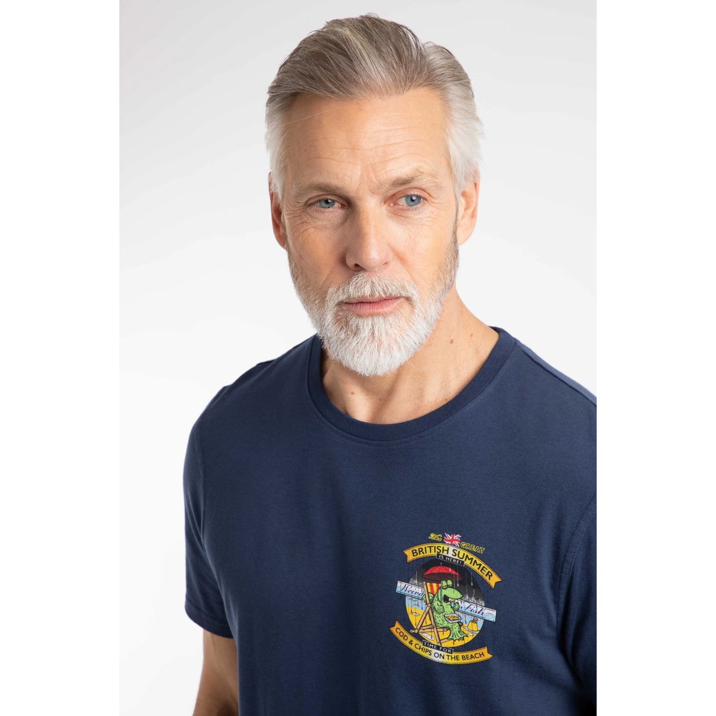 Close-up view of a man wearing a Weird Fish Cod and Chips print short sleeve t-shirt in Dark Blue