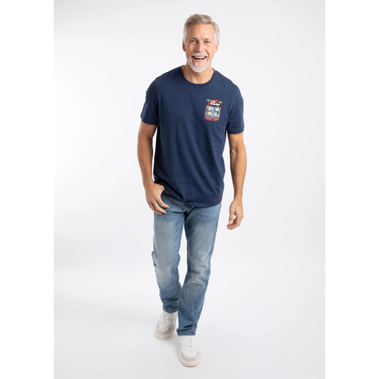 A man wearing a Weird Fish men's Cod Dwarf printed short sleeve t-shirt in Dark Blue with black  trousers.