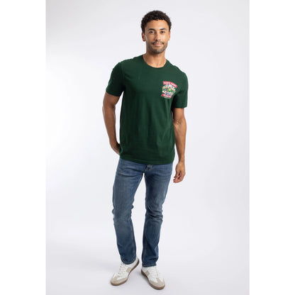 A man wearing a Weird Fish Dab's Army printed t-shirt, in beetle green, featuring a small Dad's Army TV show themed print on one side of the chest with blue jeans.