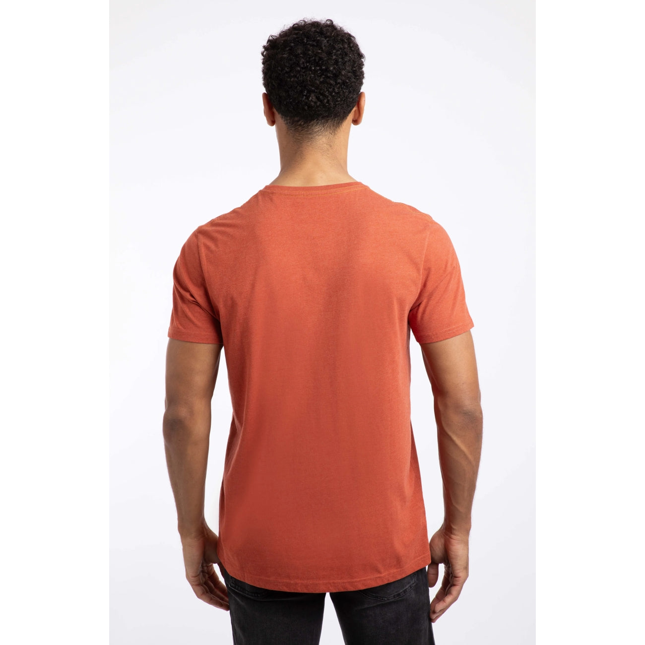 Back view of a man wearing a Weird Fish short sleeve Double Fish t-shirt in orange red on a white background