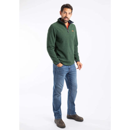 Man wearing a green Weird Fish Errill  pullover fleece and blue jeans on a white background