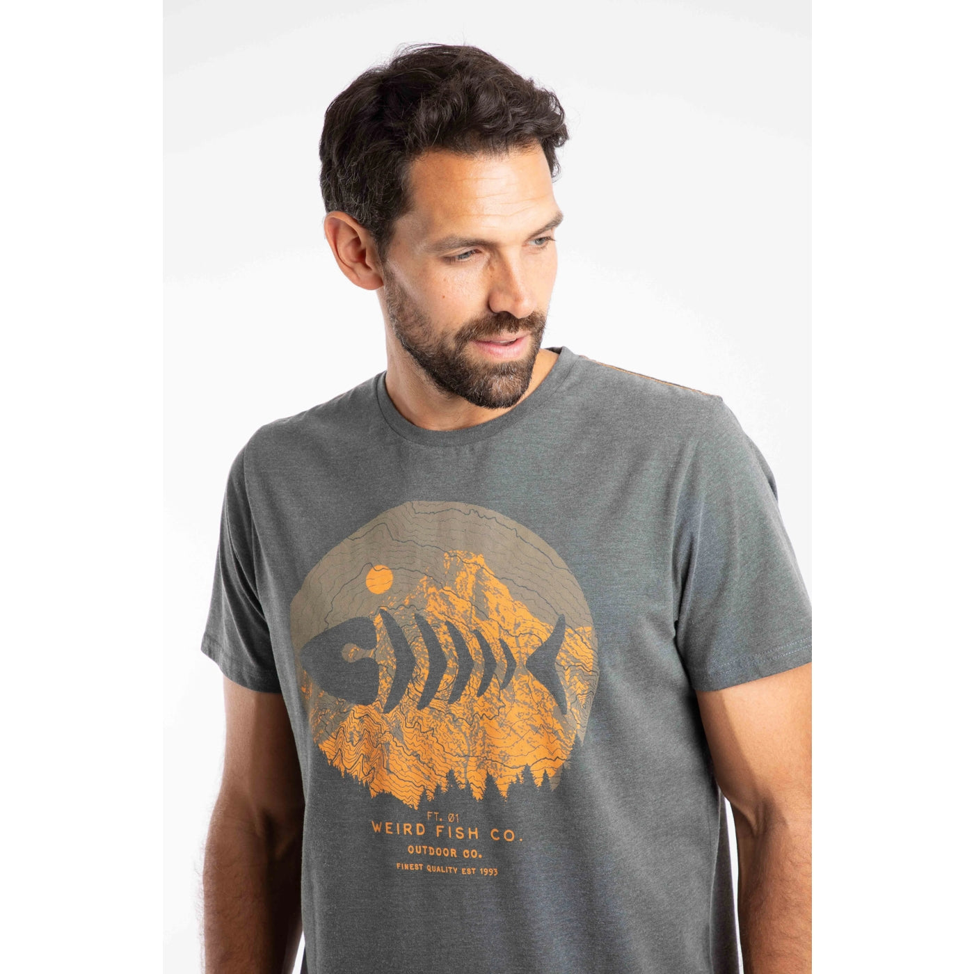 Man wearing a grey t-shirt with an orange fish and mountain graphic and 'Weird Fish Co' text.