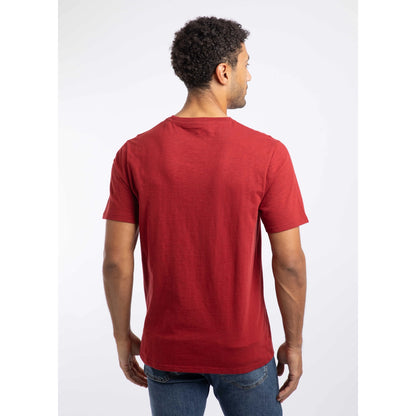 Back view of a man wearing a Weird Fish crew neck short sleeve Fished t-shirt in Barn Red with small logo on one side of the chest.