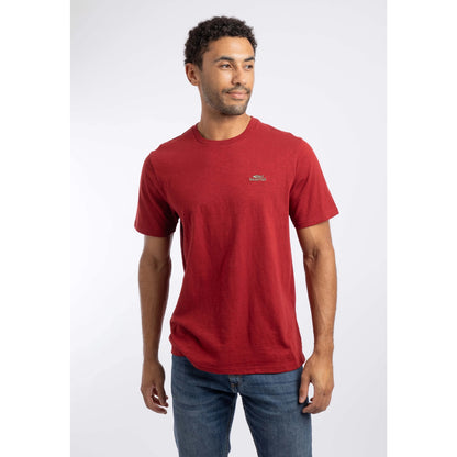 Front view of a man wearing a Weird Fish crew neck short sleeve Fished t-shirt in Barn Red with small logo on one side of the chest.