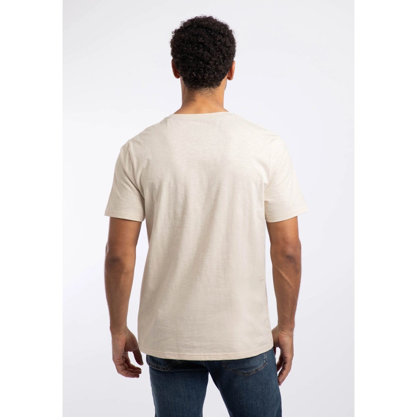 Back view of a man wearing a Weird Fish crew neck short sleeve Fished t-shirt in Egg Shell.