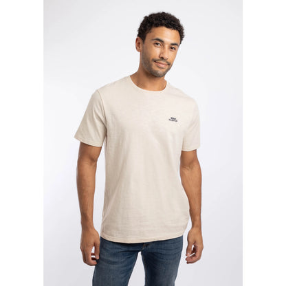 Front view of a man wearing a Weird Fish crew neck short sleeve Fished t-shirt in Egg Shell with small logo on one side of the chest.