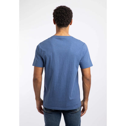 Back view of a man wearing a Weird Fish short sleeve Fished t-shirt in Faded Blue with a small logo on the chest.