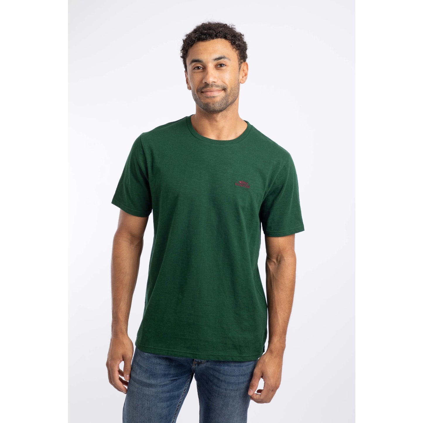 Front view of a man wearing a Weird Fish short sleeve Fished t-shirt in Pine Green, plain with a small logo on the chest
