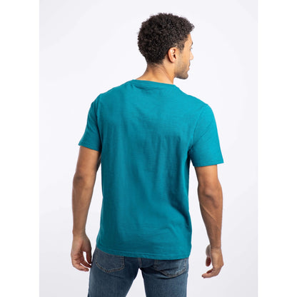Back view of a man wearing a Weird Fish crew neck short sleeve Fished t-shirt in Blue Teal with small logo on one side of the chest.