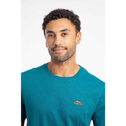 Close-up view of a man wearing a Weird Fish crew neck short sleeve Fished t-shirt in Blue Teal with small logo on one side of the chest.