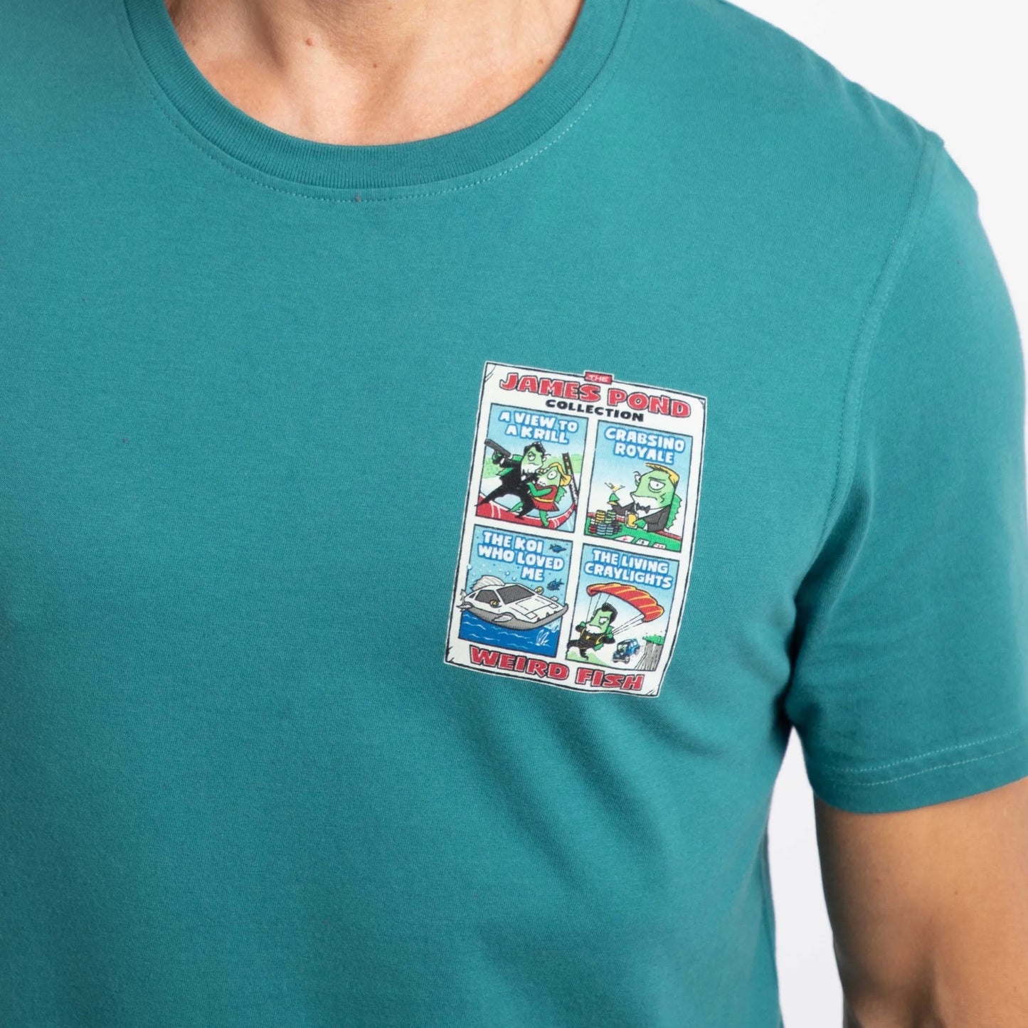 Close-up view of a man wearing a Weird Fish short sleeve James Pond printed t-shirt in Deep Teal
