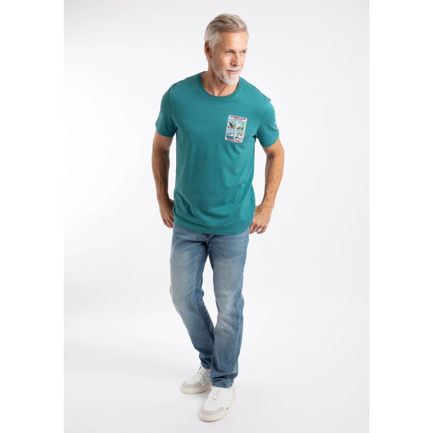 A man wearing a Weird Fish short sleeve James Pond printed t-shirt in Deep Teal with blue jeans