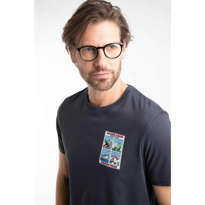 Close-up view of a man wearing a Weird Fish short sleeve James Pond printed t-shirt in Navy