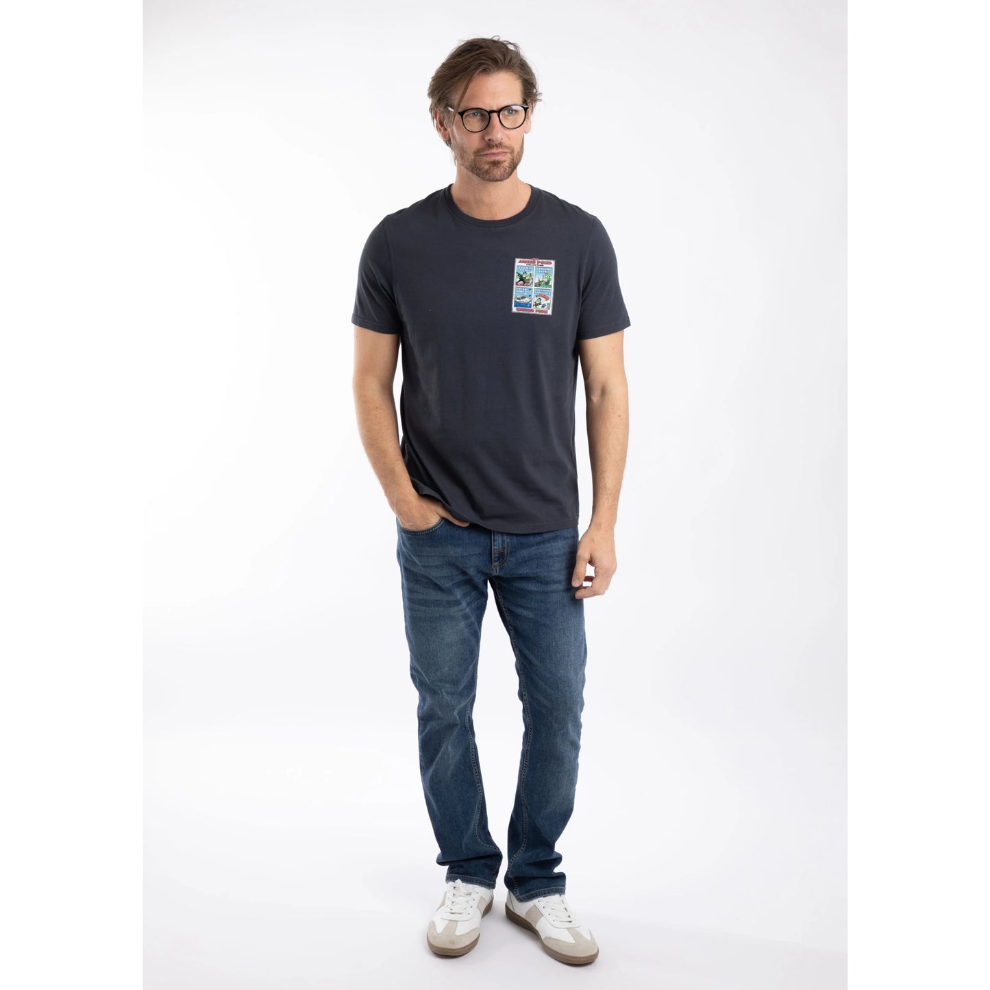 A man wearing a Weird Fish short sleeve James Pond printed t-shirt in Navy with blue jeans