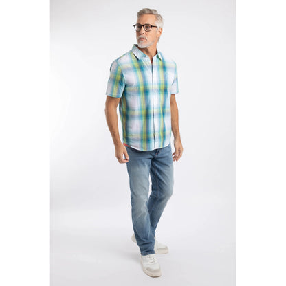 Man wearing a Weird Fish short sleeve Judd shirt in an off white, blue and lime green check pattern with blue jeans and white trainers.