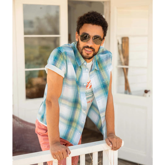 Front view of a man wearing a Weird Fish short sleeve Judd shirt in an off white, blue and lime green check pattern.