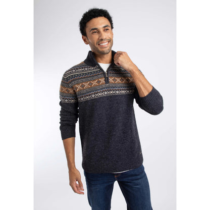 Front view of a man wearing a Weird Fish 1/4 zip Larner knitted jumper in Midnight Navy with a Fair Isle pattern across the chest and shoulders with blue jeans.