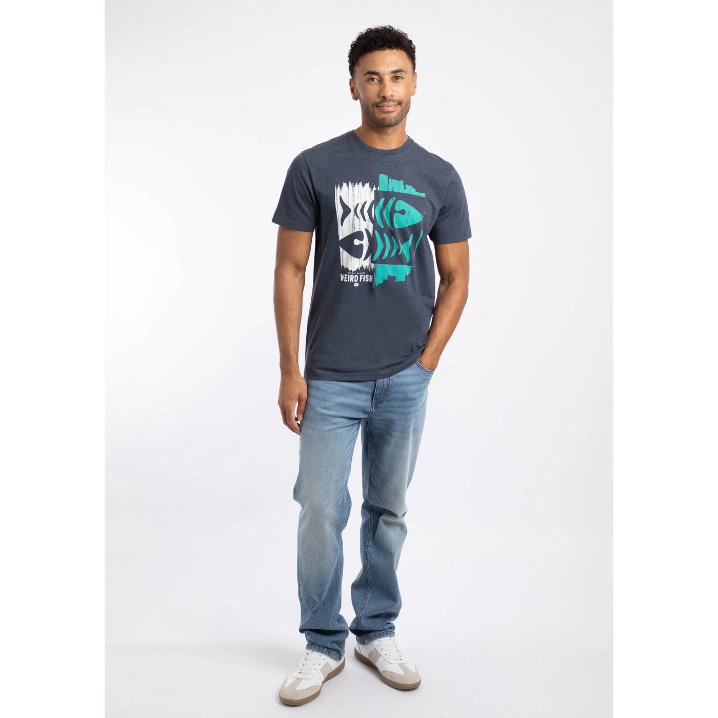 Man wearing a Weird Fish short sleeve navy Double Fish fishbones print tee with blue jeans on a white background