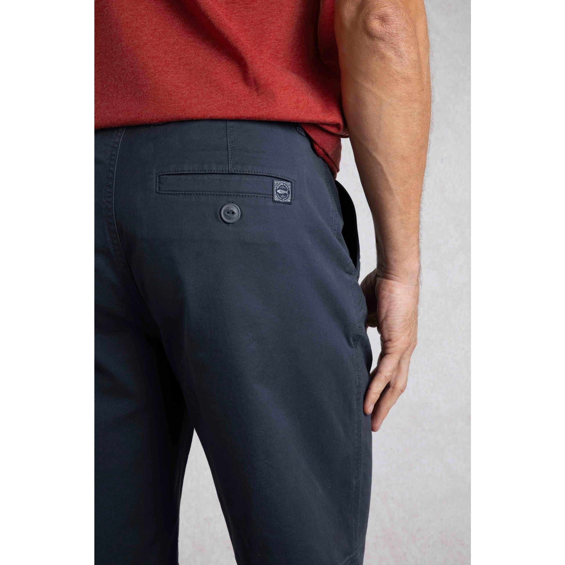 Close-up of Weird Fish mens Rayburn navy chino shorts showing back pocket detail and logo patch