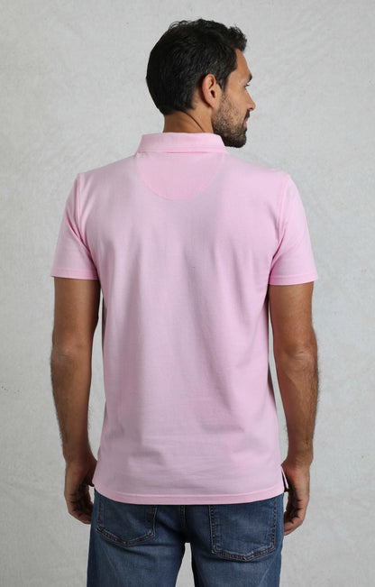 Weird Fish mens pink polo shirt shown from the back on a male model wearing jeans