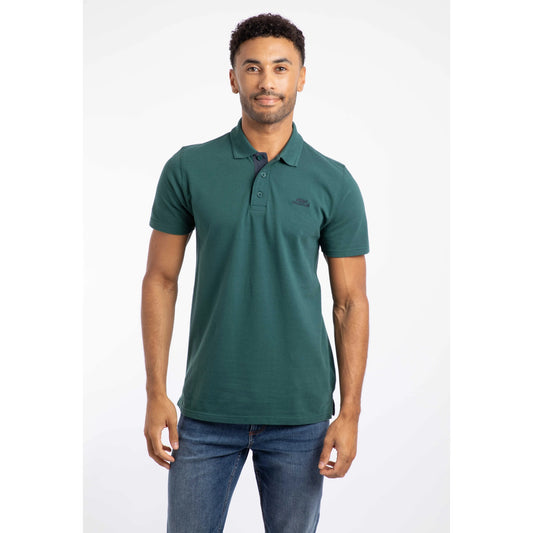 Front view of a Weird Fish mens polo shirt Forest Green worn by male model with short sleeves and button collar