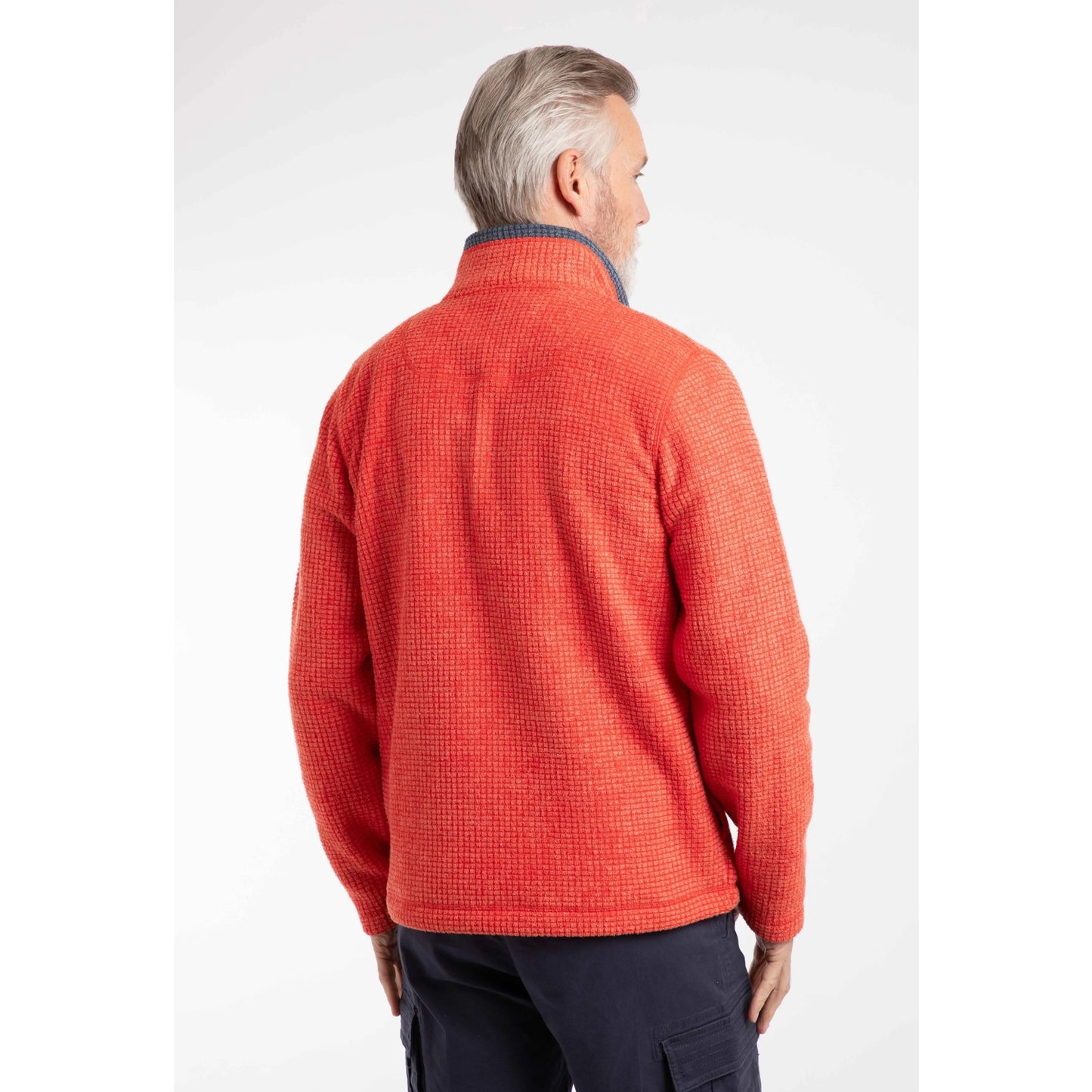 Back view of a man wearing a Weird Fish full zip Shires grid textured fleece in bright Orange Spice with contrasting navy neckline and small chest logo with navy shorts