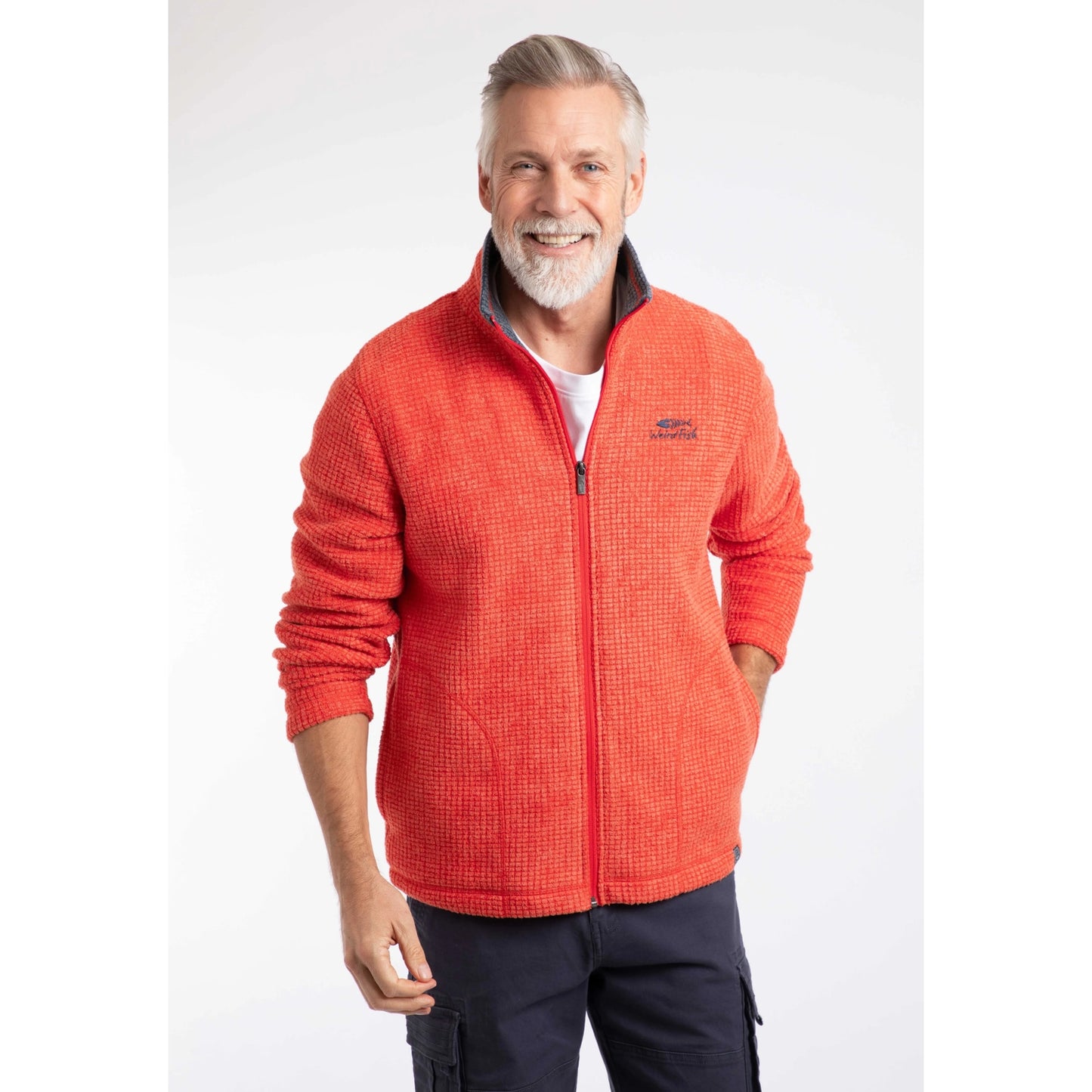 Front view of a man wearing a Weird Fish full zip Shires grid textured fleece in bright Orange Spice with contrasting navy neckline and small chest logo with navy shorts