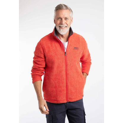 Front view of a man wearing a Weird Fish full zip Shires grid textured fleece in bright Orange Spice with contrasting navy neckline and small chest logo with navy shorts