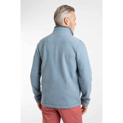 Back view of a man wearing a Weird Fish full zip Shires grid textured fleece in Light Blue with contrasting navy neckline with pink shorts