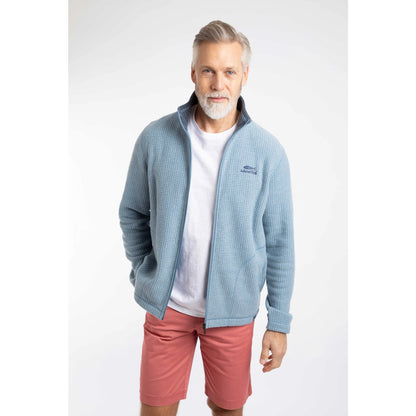 Front view of a man wearing a Weird Fish full zip Shires grid textured fleece in Light Blue with contrasting navy neckline and small chest logo with pink shorts