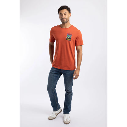 A man wearing a Weird Fish Space Coddity printed t-shirt in a Rust Leaves shade of orange with blue jeans.