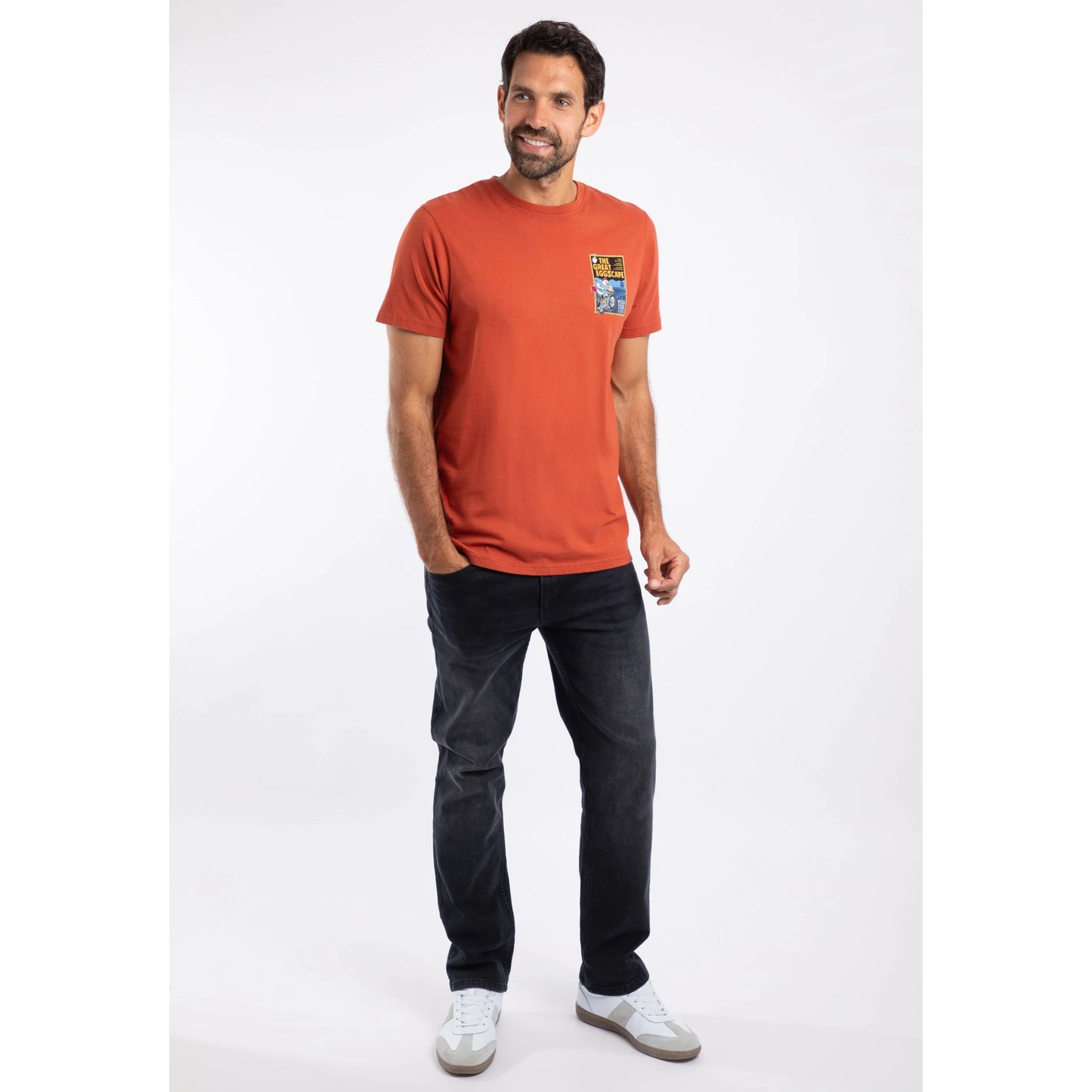 Man wearing an orange t-shirt with a print on a white background