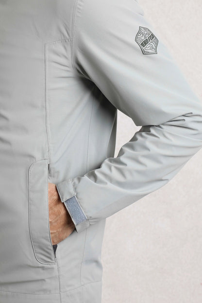 Weird Fish mens waterproof jacket grey close-up showing sleeve logo and front pocket