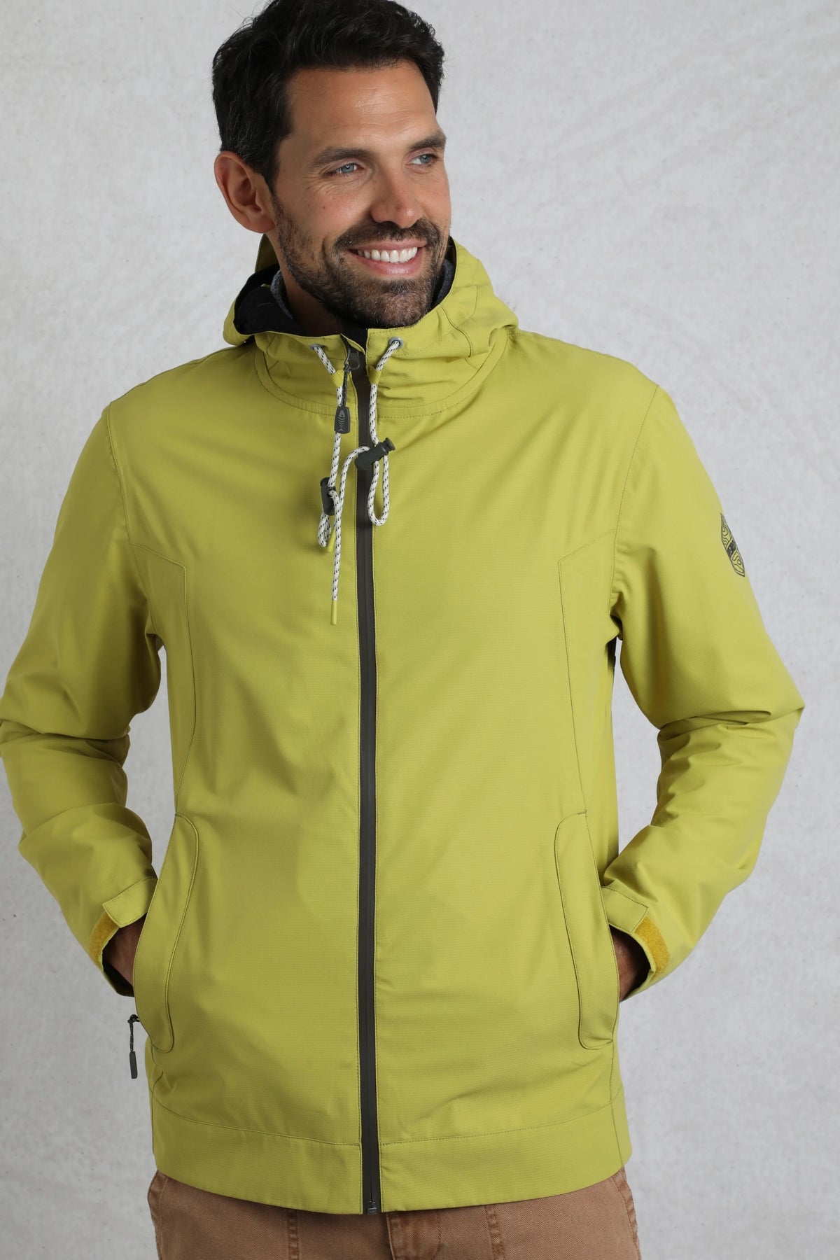 Weird Fish mens waterproof jacket tarragon in light green with hood and zippered pockets