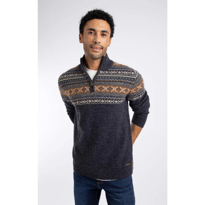 Front view of a man wearing a Weird Fish 1/4 zip Larner knitted jumper in Midnight Navy with a Fair Isle pattern across the chest and shoulders with blue jeans over a white t-shirt.