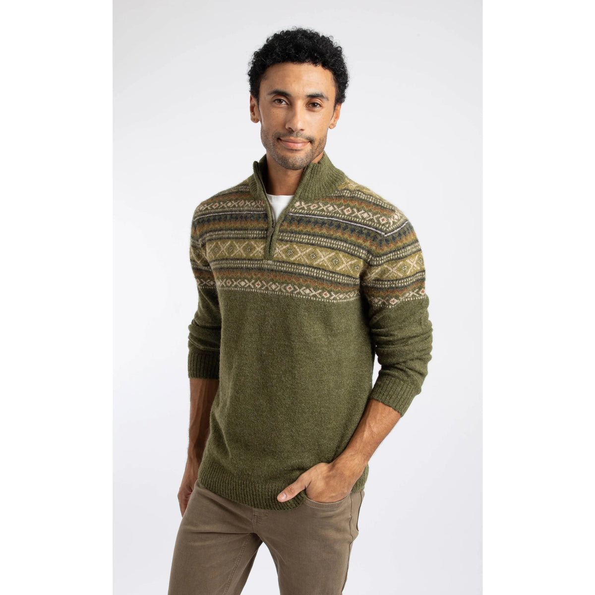 Front view of a man wearing a Weird Fish 1/4 zip Larner knitted jumper in Winter Green with a Fair Isle pattern across the chest and shoulders with brown trousers.