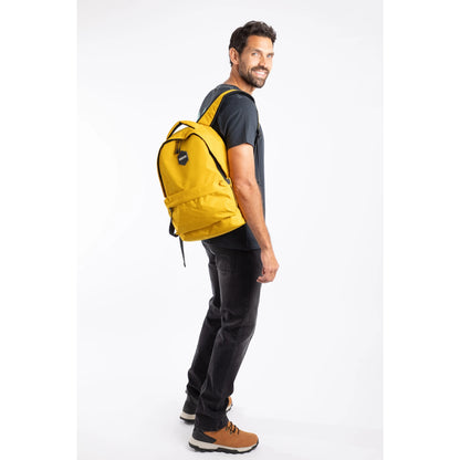 Side view of a man carrying a Weird Fish Nevis yellow backpack.