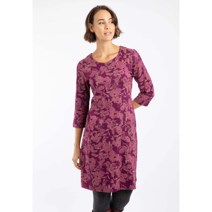 Woman wearing a plum purple Weird Fish Starshine floral dress on a white background