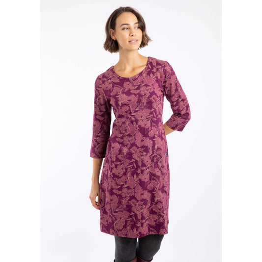 Woman wearing a plum purple Weird Fish Starshine floral dress on a white background