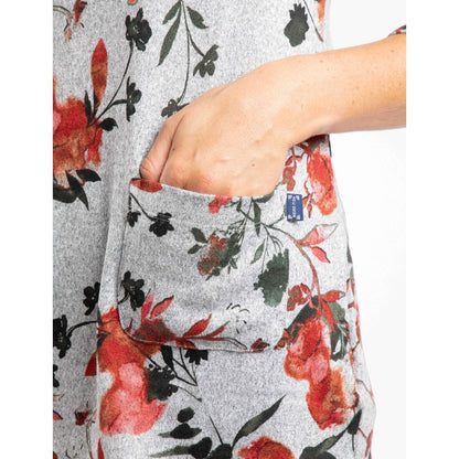 Close up of the front pocket of a Weird Fish womens floral-patterned grey Sidney tunic with a red and green floral pattern.
