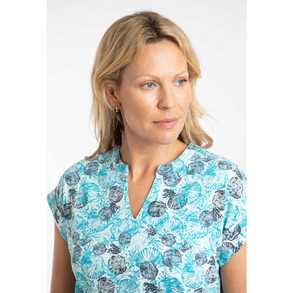 Woman wearing a blue shell patterned Weird Fish Alia t-shirt with a notch neckline on a white background