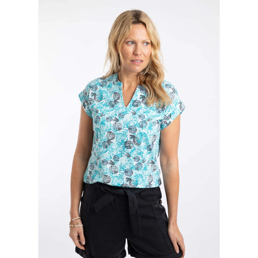 Front view of a woman wearing a Weird Fish short sleeve Alia Ocean Blue shell print t-shirt with black shorts on a white background