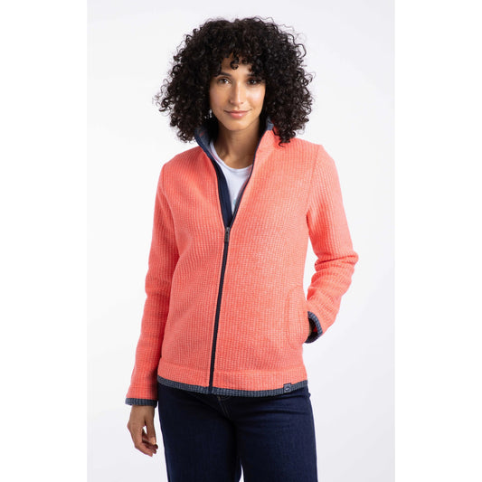 Front view of a Weird Fish womens Ariana full zip grid fleece coral with navy trim worn by woman with curly hair