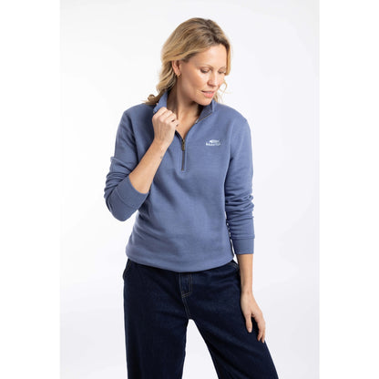 Front view of a woman wearing a Weird Fish Avery 1/4 zip plain sweatshirt in Faded Blue with a small logo on the chest
