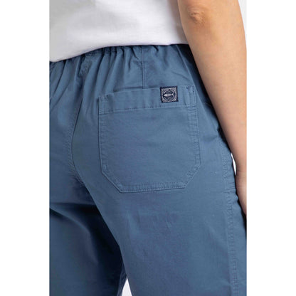 Close-up view of the back pocket with logo label on a pair of womens Weird Fish flat front Kinnie shorts in Faded Blue with elastic waist and hip pockets.