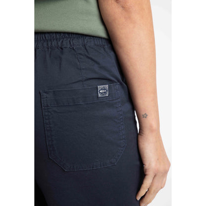 Close-up view of the back pocket with logo label on a pair of womens Weird Fish flat front Kinnie shorts in navy with elastic waist and hip pockets.