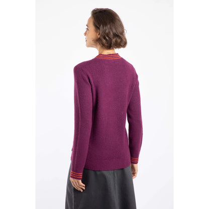 Back view of a woman wearing a Weird Fish Beet purple knitted jumper with a white background