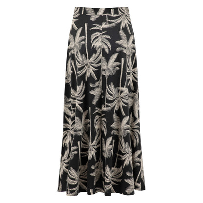 Back view of a womens Weird Fish Eloriah midi jersey skirt in black with a beige palm tree pattern.