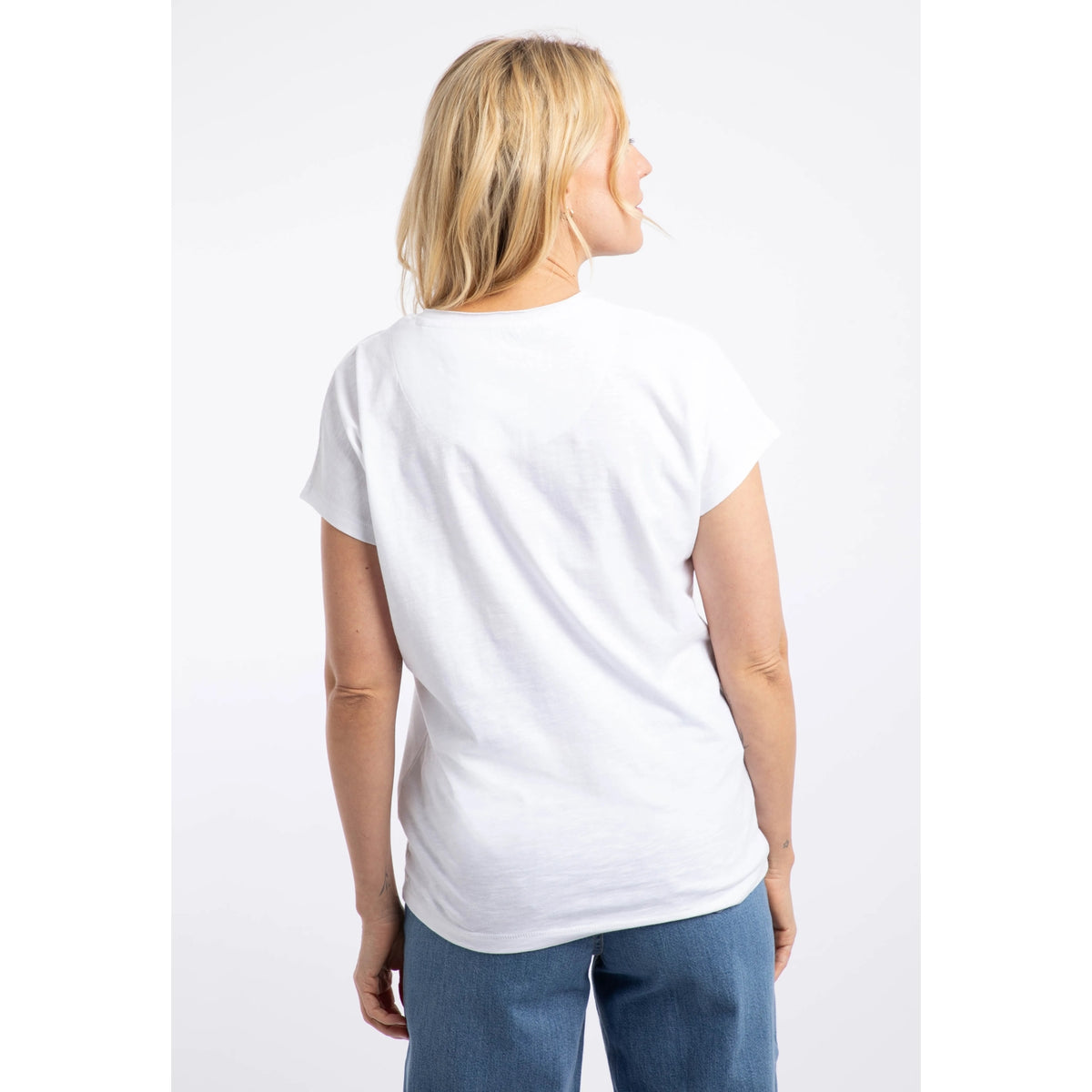 Back view of a woman wearing a Weird Fish white Puffin print t-shirt.